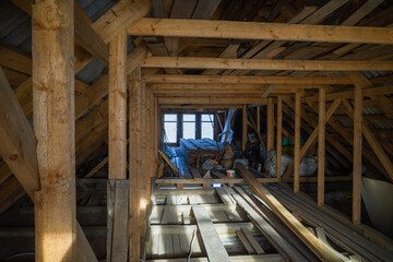 attic room with roof rafters of a wooden house