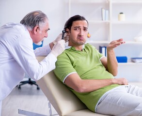 Male patient visiting doctor otolaryngologist