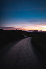 A path over the hills towards the Alps during blue hour