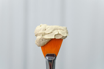 cosmetology facial gel peeling mask or butter on brush. Skincare and cosmetology spa concept.