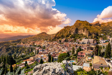 Taormina, Sicily, Italy. Panoramic view over Taormina old town and mountains in background. Popular tourist destination on Sicily