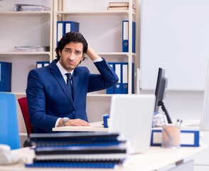 Young handsome businessman working in the office