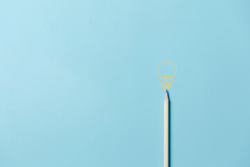 Pencil with light bulb and word idea on blue background. Creativity inspiration ideas concept. Education concept image. Creative idea and innovation. Pencil and light bulb.