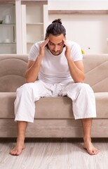 Young man doing physical exercises at home