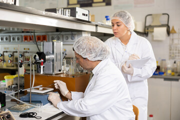 Scientist and his assistant conduct scientific experiments in a chemical laboratory