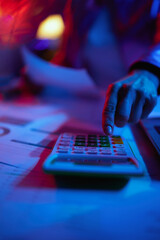 Closeup on modern woman with calculator and documents