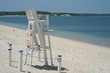White Lifeguard Station on sandy beach in the sun