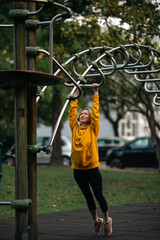 A woman doing exercises in the city park.