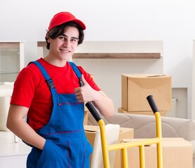 Young male contractor with boxes working indoors