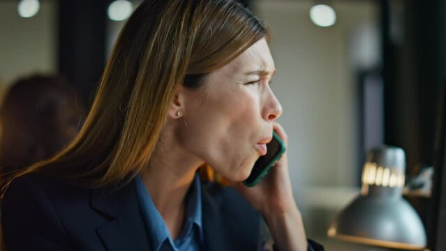 Upset employee talking smartphone close up. Frustrated woman discuss project