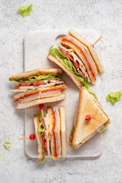 Club sandwich with ham, cheese, tomatoes, lettuce, and toasted bread