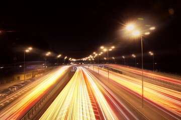 Fototapeta na wymiar Road traffic, motion blur effect. View of car light trails at night