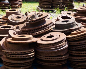 A PIle of Rusty Discs Stacked in the Bright Sunlight in an Old Factory