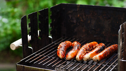 Grilled pork sausage on a cast iron grill, top view