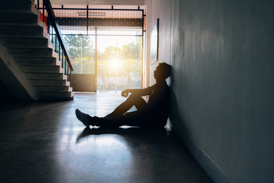 Asia You Man Sitting Alone.He Sitting In Building.man Very Sad And Depressed.sad,alone,suicide,despair,sickness,photo Health And Disappointment Concept.