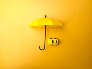 Yellow umbrella covered yellow car