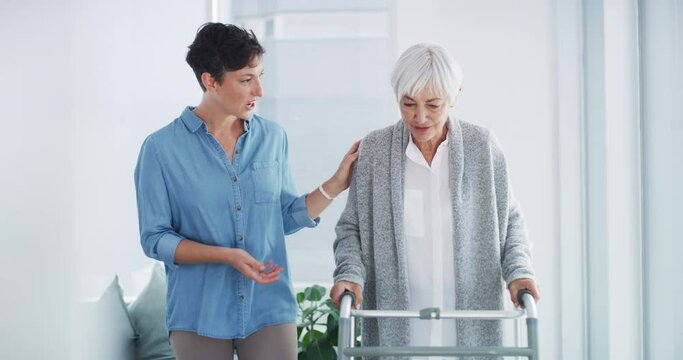Caregiver helping a senior woman to walk with a crutch walker in a retirement home. Healthcare, support and female person teaching elderly mother with disability to exercise in rehabilitation center.