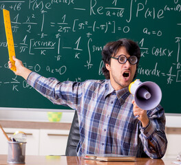 Funny male math teacher in the classroom