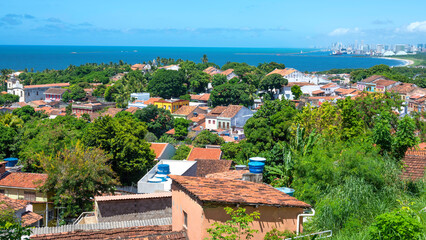 View of the architecture of the historic city of Olinda in Pernambuco, Brazil with its 17th century Baroque style buildings on cobblestone streets in the summer sun.