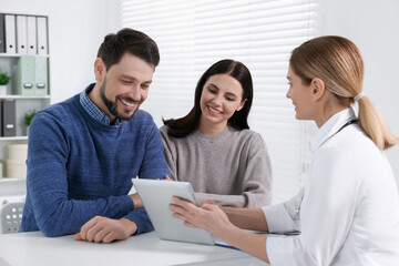 Couple having appointment with fertility doctor in clinic. Patient consultation
