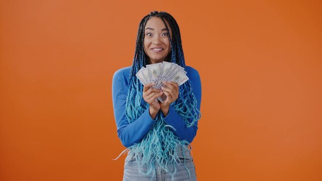 Young African American woman rejoices receiving money