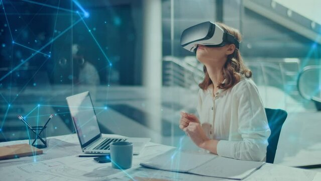Beautiful Business Woman Wearing Virtual Reality Headset. Woman Working Using VR Goggles at Office. Growth of the VR Industry. Applications for Business. Virtual Office Environment