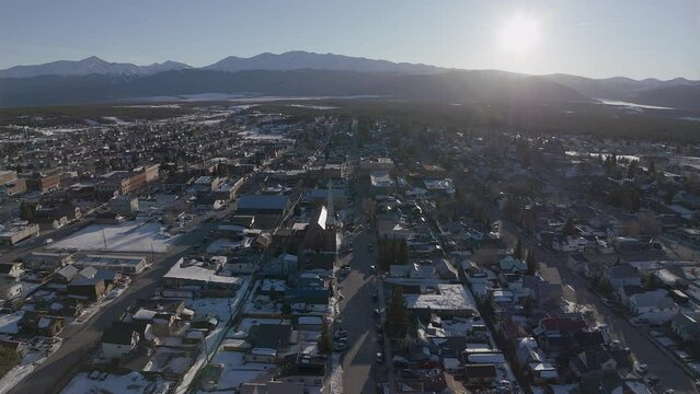 Leadville Aerial cinematic drone Colorado historic downtown winter spring snowy street buildings late afternoon early evening blue sky bright sunshine forward pan up reveal movement