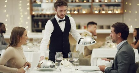 Love, toast or couple in restaurant in celebration of a happy marriage anniversary at dinner at night. Waiter, romantic man or woman fine dining eating food bonding or drinking wine on valentines day
