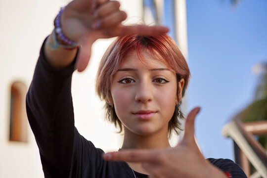 Head Shot Portrait Latin Woman Teenager Gesturing Framing With Hands