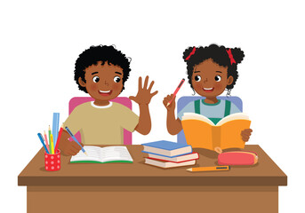 Cute African school kids studying doing homework together at the desk
