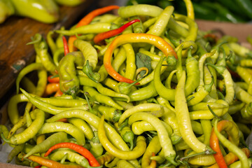 green hot peppers displayed for sale in the market