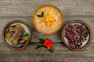 Assorted of Indonesian traditional porridge, such as  bubur jagung Mutiara (corn sago), bubur mutiara (sago) bubur biji salak (sweet potatoe). Indonesian food. 