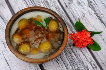 Bubur Biji Salak, sweet potato porridge on the wooden table. Indonesian traditional porridge. Indonesian food. Top view.  