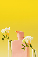 Pink dispenser with liquid cosmetic for routine care in the bathroom. Skin and hair care. Close up