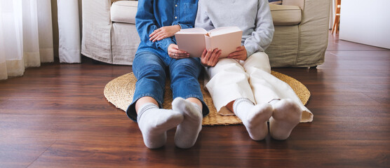 Closeup image of a couple people enjoyed reading books together at home