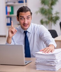 Naklejka premium Young male employee sitting in the office