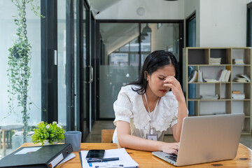 Stressed angry unwell woman working in office looking at laptop computer, Business officer employee...