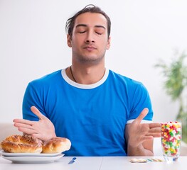 Young hungry man in dieting concept