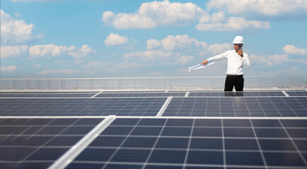 Engineers walking on roof inspect and check solar cell panel by hold equipment box ,solar cell alternative power factory concept.