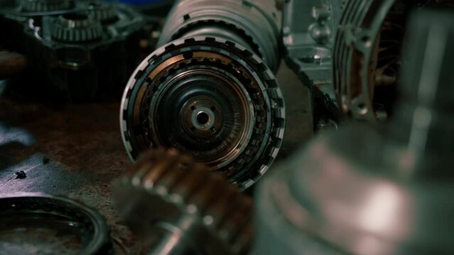 Close-up of the gearbox and clutch of a car taken from a luxury car for repair which lie on the table