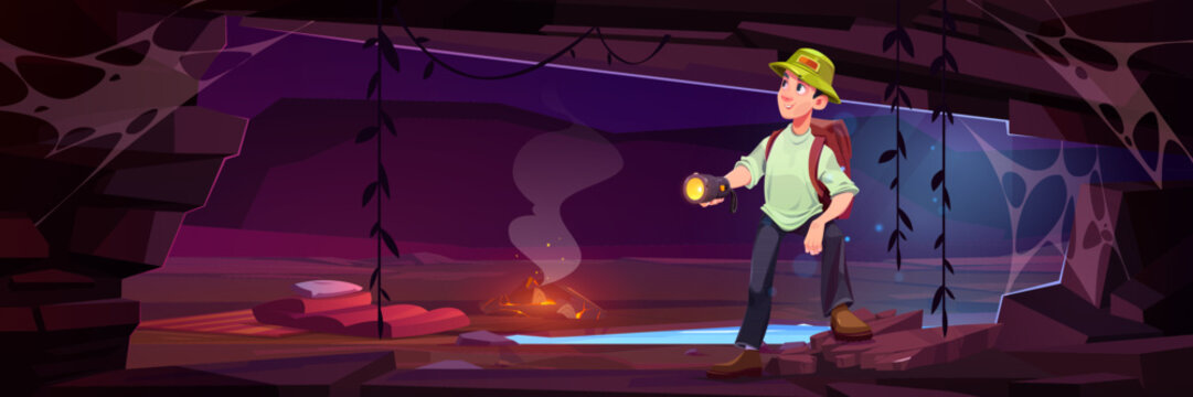 Male traveler standing in cave with flashlight. Vector cartoon illustration of happy man with backpack exploring mountain grotto, underground lake, lianas on wall, campfire and sleeping bag on ground