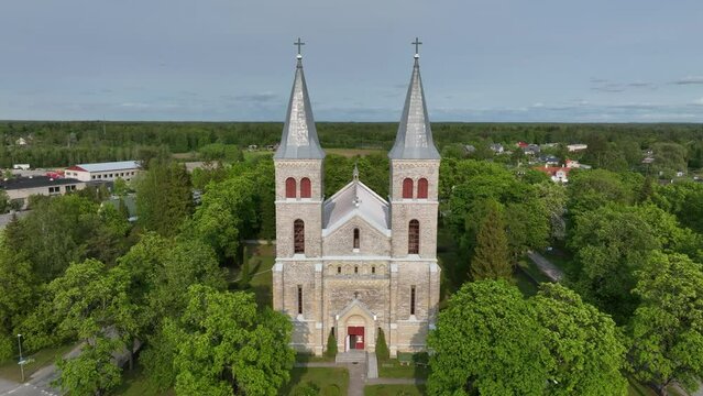 Aerial of Rapla Maarja-Magdaleena Church which is the only rural church with two towers in Estonia.The drone flies between the two towers of the church.