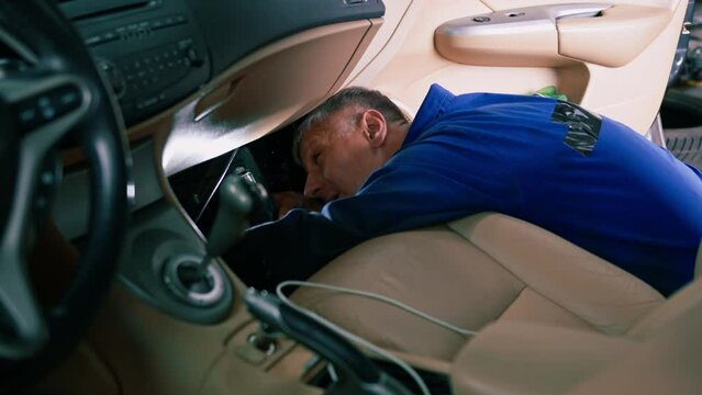 Auto mechanic changing the air filter in the cabin of a luxury car Concept of caring for expensive cars and loving used cars