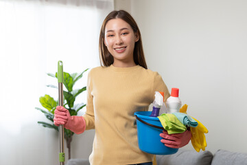 Household clean up, asian woman worker holding bucket and mop when cleaning is done at home. Maid, housekeeper cleaner organizing messy dirty and untidy to tidy, housekeeping housework or chores.