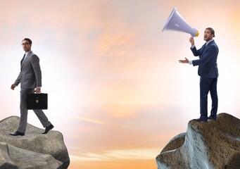 Businessman shouting with loudspeaker at others