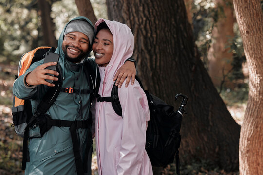 Happy, black couple and hiking in hug for selfie, profile picture or vlog in travel adventure in nature. African man and woman hiker hugging for photo, memory or social media and trekking in forest