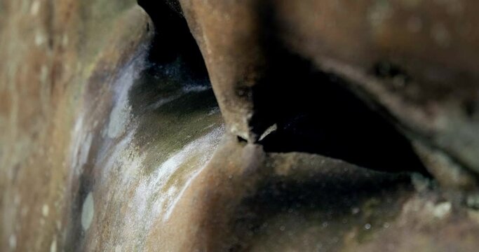 Climber slips and falls after attempting to grip a small edge hold while scaling a cliff.