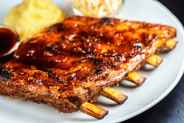 Tasty spare ribs grilled to perfection and served on a plate, the perfect meal for any occasion!