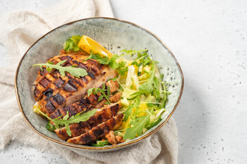 salad with grilled chicken, orange, cucumber and arugula