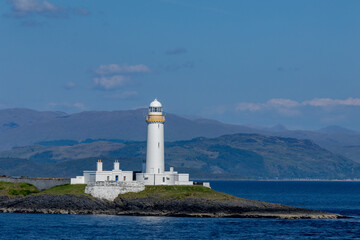 Fototapeta na wymiar Lismore lighthouse, located in the Firth of Lorn on the island of Eilean Musdile at the entrance to Loch Linnhe. This lighthouse was designed by engineer Robert Stevenson